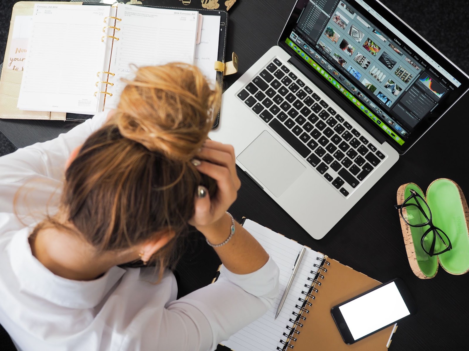 Stressed person with hands on head, looking overwhelmed
