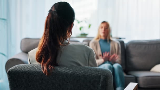 Psychologist speaking with a client in a supportive therapy session